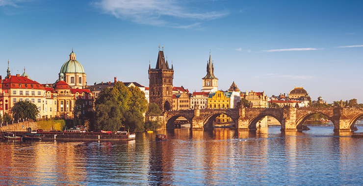 A panoramic view of Prague, Czech Republic, featuring the iconic Charles Bridge and the historic Old Town