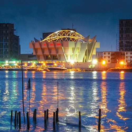 A night view of the Civic Centre in Lagos Nigeria illuminated by colorful lights