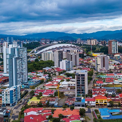 A stunning scene of San José Costa Rica capturing the city's diverse architecture and the surrounding mountains