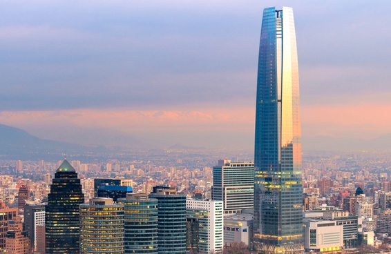 A scenic view of the Gran Torre Santiago skyscraper in Santiago Chile illuminated by the setting sun